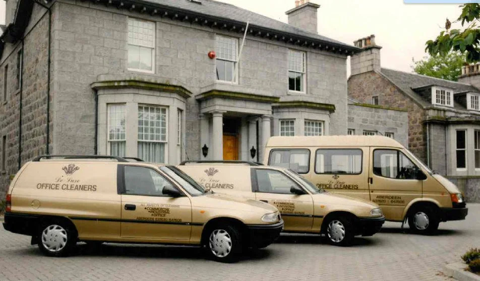 De-Luxe Office Cleaners vans and staff outside the office